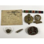 A Second World War South Lancashire Regiment plastic cap badge, together with sundry other items