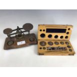 A 19th century set of brass postal scales and weights, together with one further cased set of