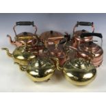 Seven brass and copper kettles together with a teapot