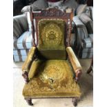 A Victorian upholstered and carved oak open armchair