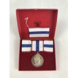 A QEII Silver Jubilee medal, cased