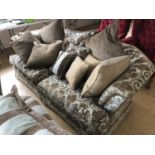 A contemporary three-seater sofa with scatter cushions (carcass matches adjacent lot)