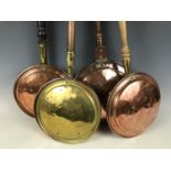 Four copper and brass bed warming pans