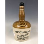 A stoneware McCallums Perfection Scots Whisky bottle