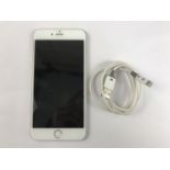 An Apple iPhone 6s and charger, near as-new, unlocked, with factory default settings