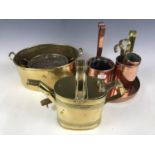 A brass watering can together with a copper frying pan etc