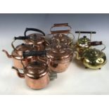 Seven copper and brass kettles