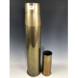 A large artillery brass shell case and one other