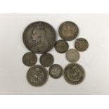 A small quantity of silver coins QV-KGV, to include a crown, shillings, and 3d coins, 51.2g