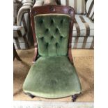 A Victorian button upholstered and carved mahogany nursing chair