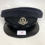 A mid-20th Century peaked cap with Nigeria Police cap badge