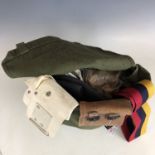 A quantity of largely post-War military head gear and personal kit