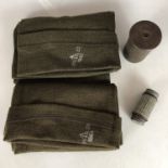 A Second World War gas mask anti-dim kit, a shell case and two knitted scarves / comforters