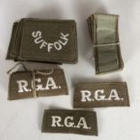 A quantity of original un-issued Great War British Army slip-on cloth shoulder titles, Royal