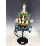 A vintage tinplate oscillating sculpture, modelled in the form of ship bobbing in the waves at the