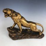 A large patinated gilt plaster sculpture of a lioness, second quarter 20th Century, 40 cm x 30 cm