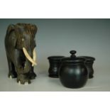 Three ebony dressing table jars an Indian carved wooden elephant