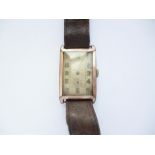 A 1930s rolled gold tonneau-cased wrist watch (a/f)