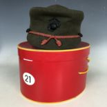 A post-War US Marine Corps woman's peaked cap and carton