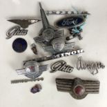 A number of classic Morris, Ford, Hillman and other car badges