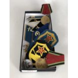 A quantity of post War Soviet bloc military badges etc