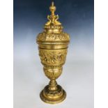 A Victorian Baroque ormolu goblet and cover, the cup bas-moulded with a frieze depicting Poseidon