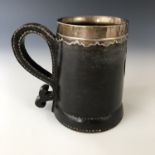 An early 20th century white-metal mounted leather black jack or tankard by Gorham Manufacturing