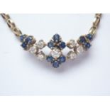 A 9ct gold, diamond and sapphire necklace, comprising an openwork geometric arrangement of