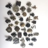 A large quantity of City of London Regiment and other cap badges