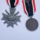 A German Third Reich War Merit Cross with swords second class, together with a War Merit Medal