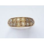 A Victorian 18ct gold and pearl dress ring, the lenticular face sunken and pellet set with black and