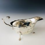 A George V silver sauce boat, of helmet form with a flying scroll handle, James Woods and Sons,