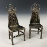 A pair of Victorian silver miniature hall chairs, each having repousse moulded back splats depicting