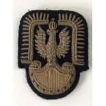 A Second World War Free Polish Air Force officer's bullion-embroidered cap badge