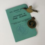 A Second World War City of Carlisle Fire Guard appointment card together with a Home Guard lapel