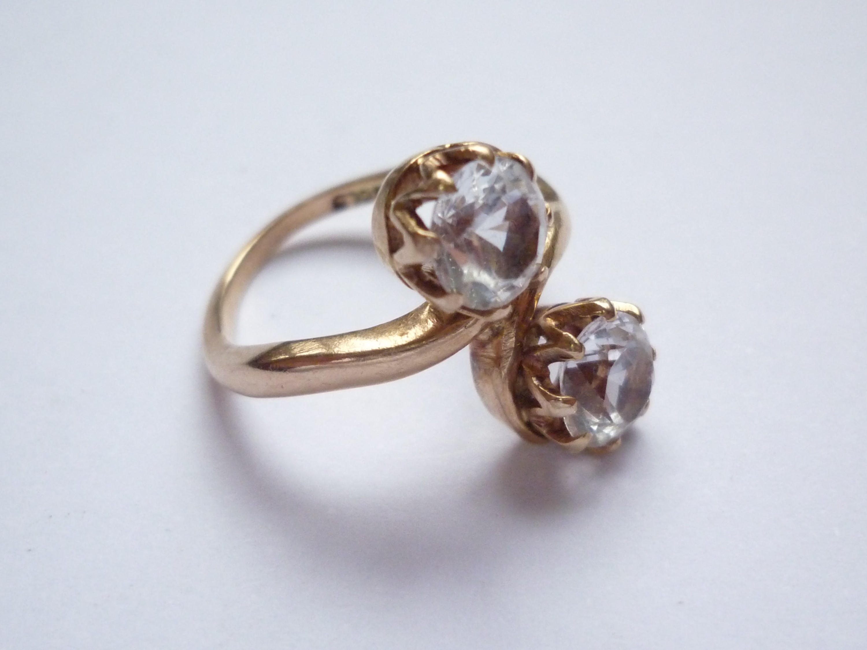 A vintage two-stone white sapphire and yellow-metal ring, the faceted round-cut sapphires each of - Image 2 of 2
