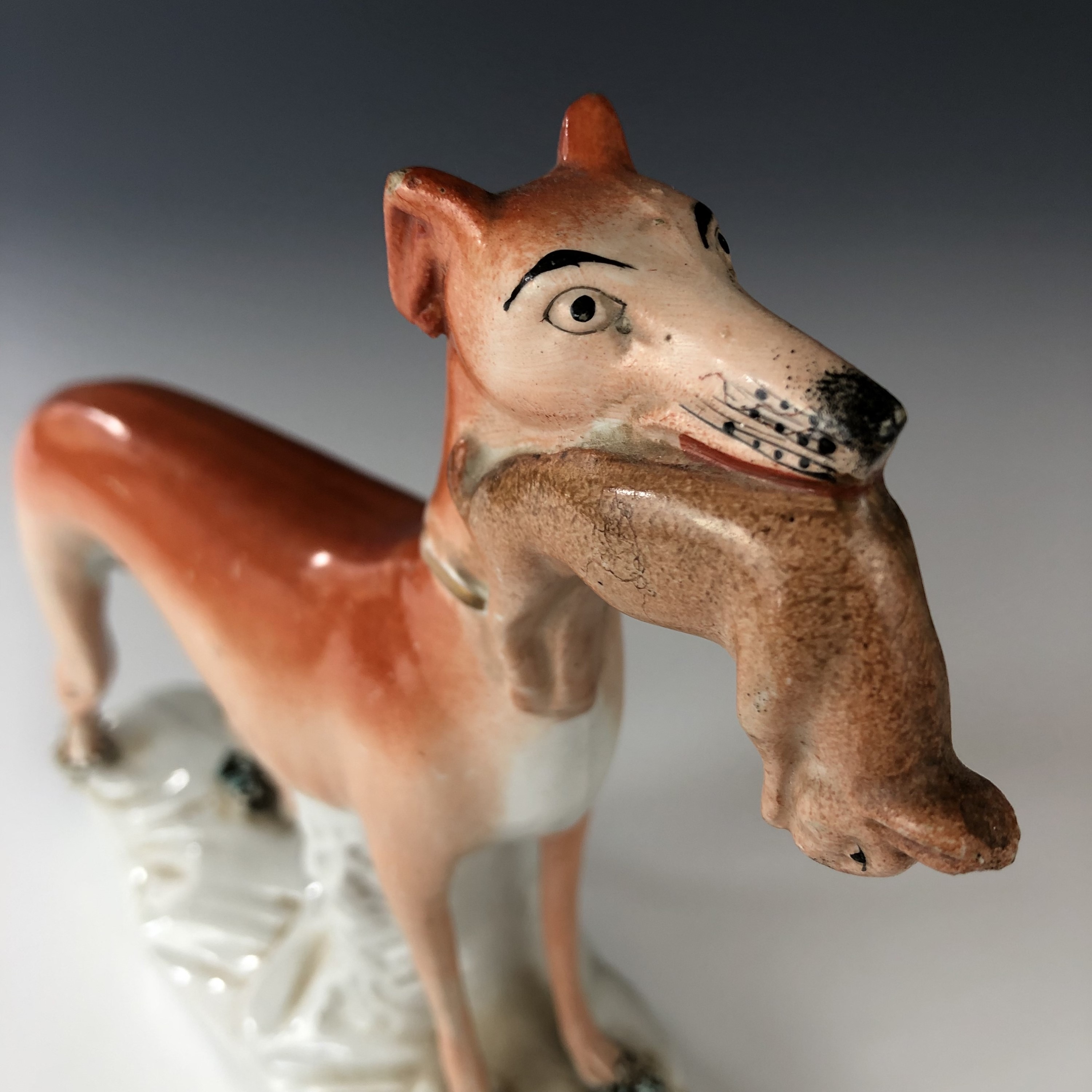A 19th century Staffordshire pottery figurine of a greyhound clutching a rabbit in its mouth, 20 cm - Image 3 of 3