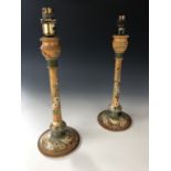 A pair of Arts and Crafts influenced wooden table lamps, with hand-painted decoration, circa