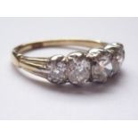 An antique five-stone diamond ring, the Old European Cut diamonds being rub and claw set in a graded