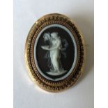 A Victorian yellow-metal and carved cameo brooch after the antique, depicting a Grecian goddess,