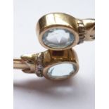 A 9ct gold, aquamarine and diamond bangle, of torque form, terminating in oval-cut aquamarines of