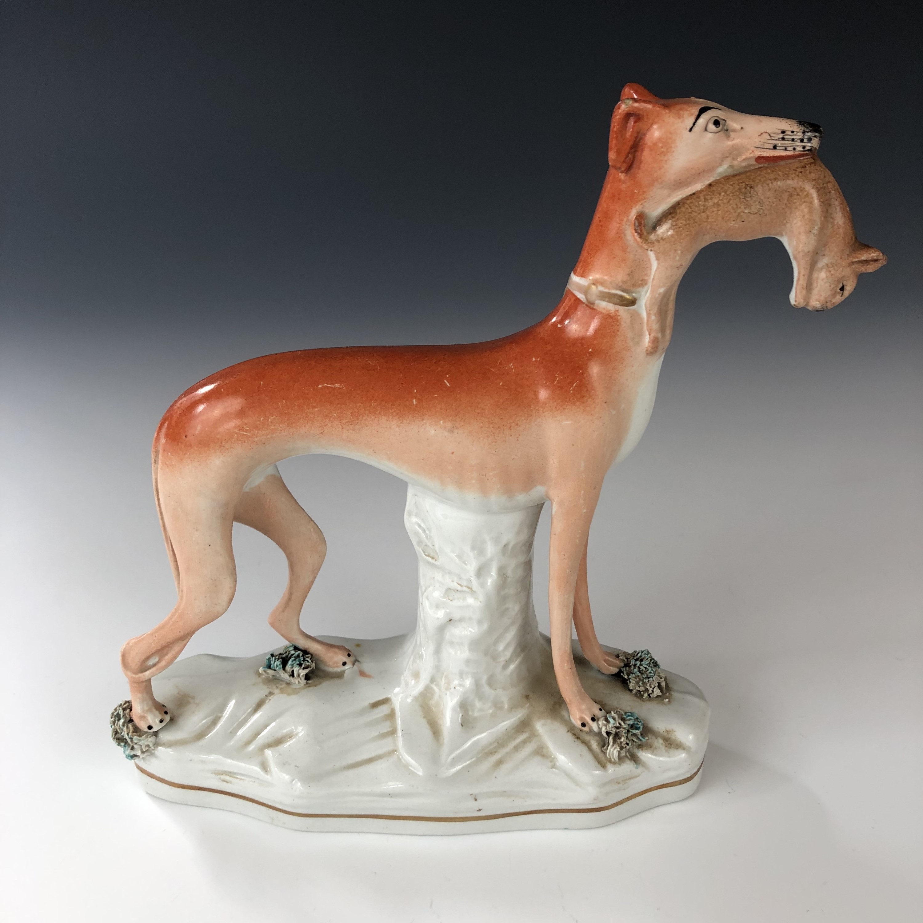 A 19th century Staffordshire pottery figurine of a greyhound clutching a rabbit in its mouth, 20 cm - Image 2 of 3