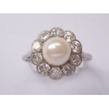 An early 20th century platinum, diamond and pearl dress ring, in a flower head cluster