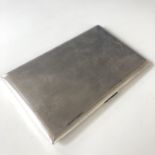 A George V silver cigarette case, with engine-turned decoration, opening to reveal an engraved