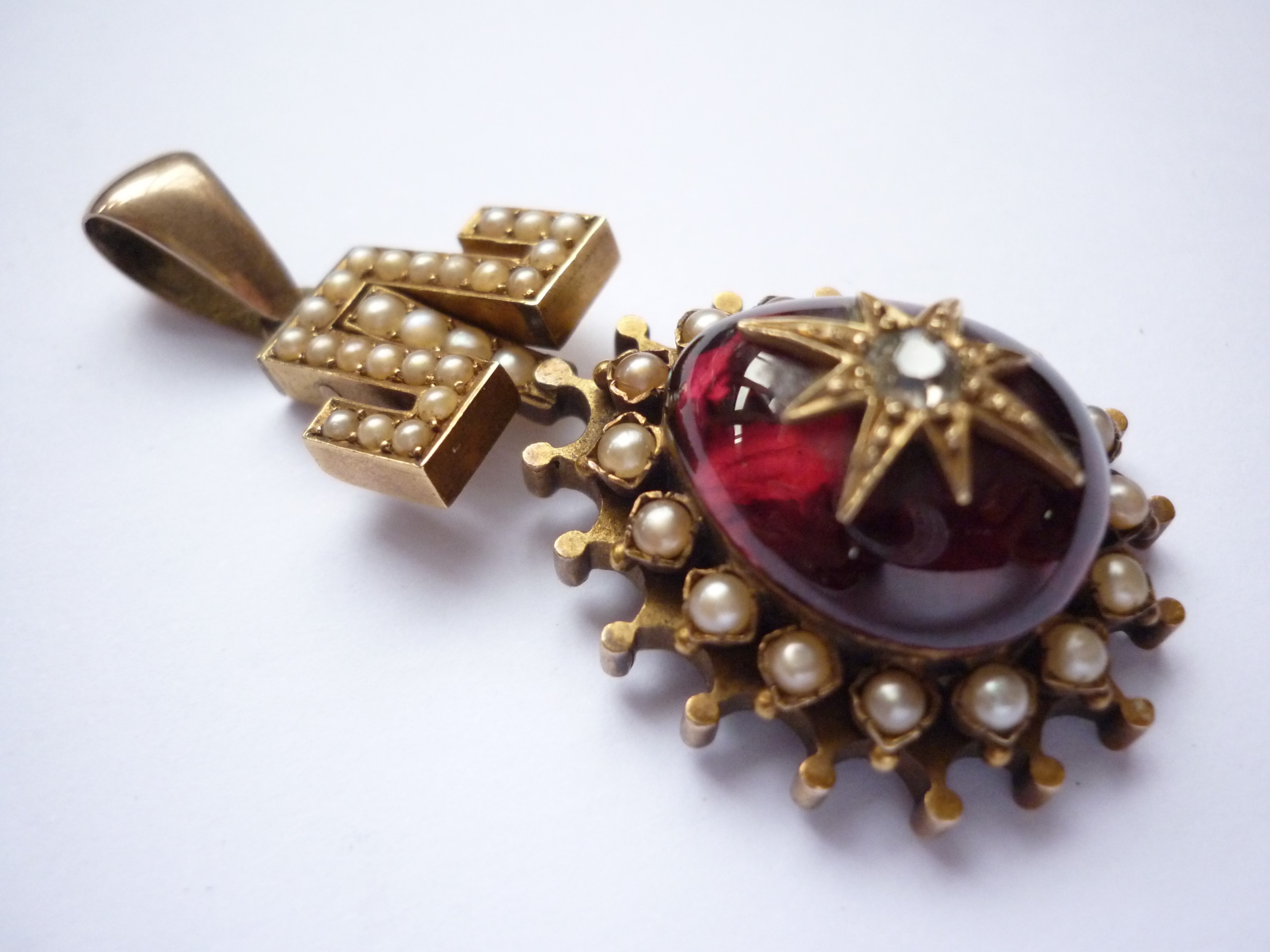 A Victorian diamond, garnet and pearl pendant of antique influence, having a pivoting Greek key - Image 2 of 2