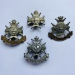 A Victorian Sherwood Foresters glengarry badge, a Worksop College OTC cap badge and two others