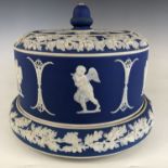 A 19th century blue Jasperware cheese dome and stand, decorated with a band of oak leaves and acorns