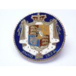 An 1834 champleve enamelled, parcel-gilt and brooched William IV silver Halfcrown coin