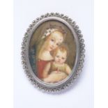 A vintage a portrait miniature brooch depicting the Madonna and child, hand-painted over ivory, in a