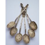 Six Canton white-metal coffee spoons, having bass-relief moulded floral bowls and stems in the